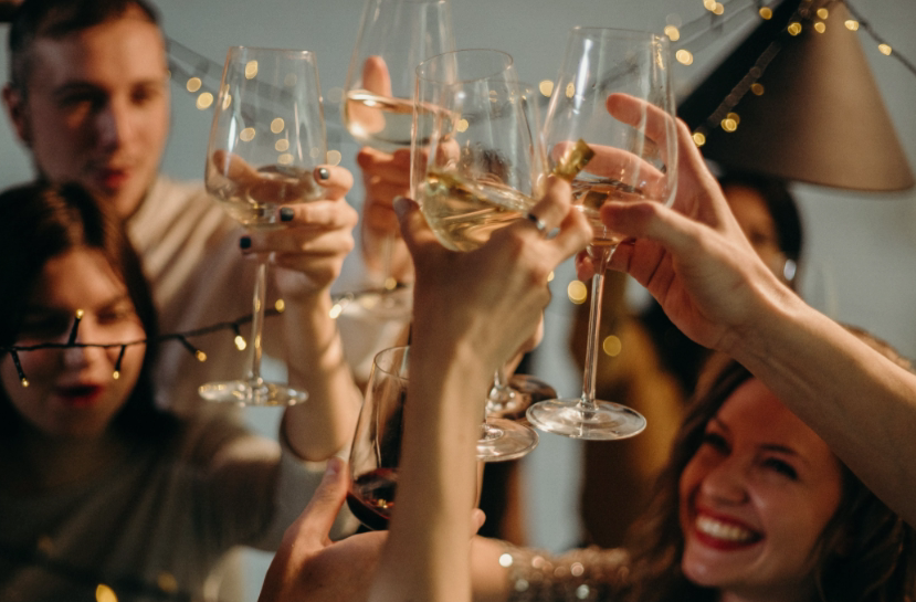 friends clinking wine glasses at a celebration